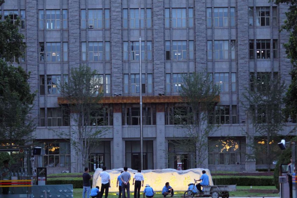 Gardeners work outside the Central Party School in Beijing. Photo: Simon Song