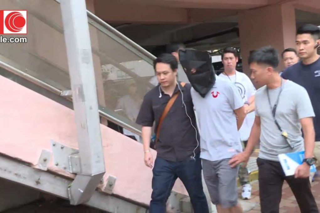 Police make an arrest after raiding a flat on the Ping Tin Estate in Lam Tin. Photo: Cable TV
