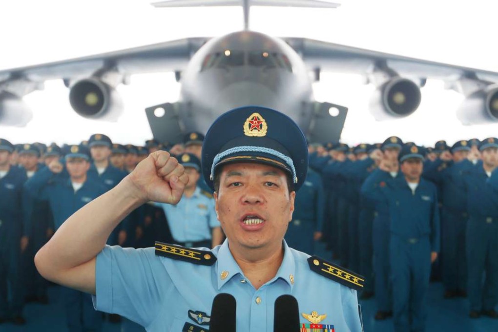 Chen Gang (front), a division commander of the People's Liberation Army Air Force, takes the oath at the Y-20’s handover ceremony in Chengdu on Wednesday. Photo: Xinhua