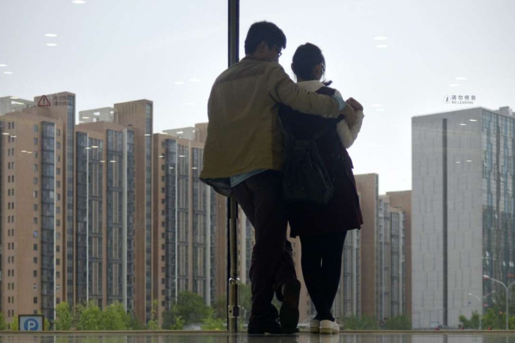 A couple in Beijing. CASS is warning that in China’s larger cities, some are now borrowing as much as nine times their own money to buy a property. Photo: Wang Zhao, AFP