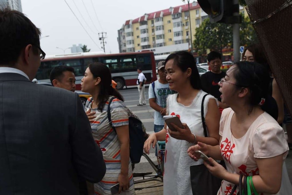 Wives of detained human rights lawyers pictured earlier this month meeting diplomats as they attempted to hand in a formal complaint at an office of the Supreme People’s Procuratorate in Beijing. Photo: AFP