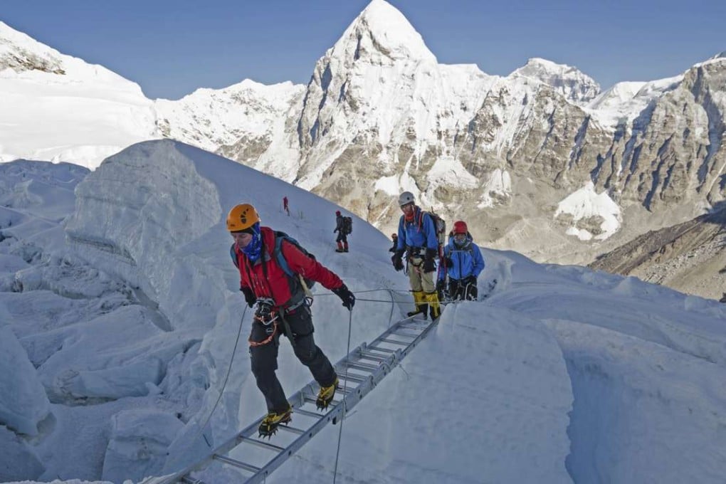 Crossing ladders on Mount Everest in Sagarmatha National Park, Nepal.