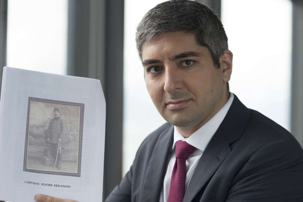 Henri Arslanian holds a picture of his paternal great-grandfather, Capitaine Captain Dr Kevork Arslanian, circa 1914. Picture: Antony Dickson