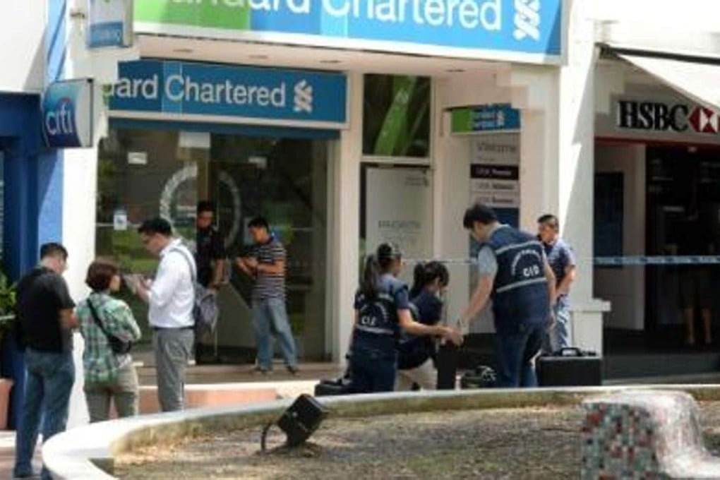 A man stole more than US$22,000 from a Standard Chartered branch using nothing but a piece of paper, Singapore police said. Photo: