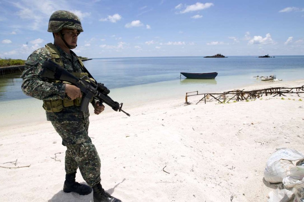 A Filipino soldier patrols in the Spratly group of islands in the South China Sea. Photo: Reuters