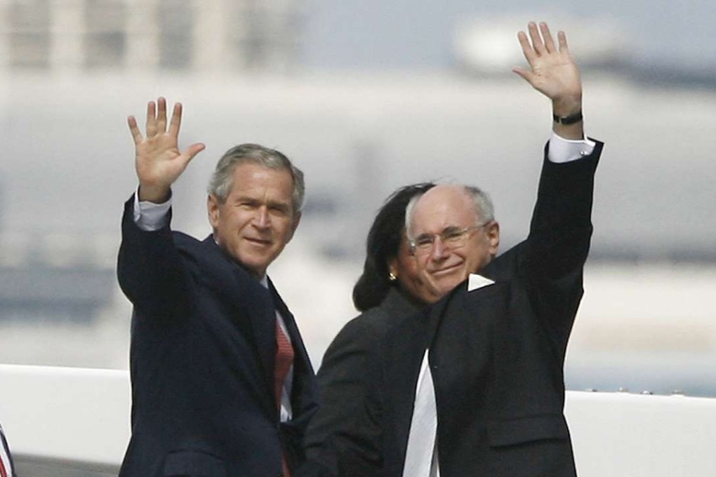 Former prime minister John Howard and US president at the time George W. Bush touring Sydney Harbour in 2007. Photo: Reuters