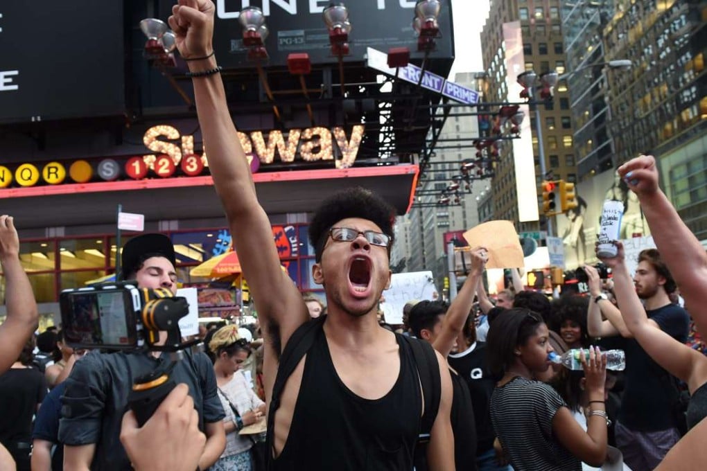 Demonstrators march through the city to call for justice for Alton Sterling and Philandro Castile as they rally in the middle of Times Square July 7, 2016 in New York. Photo: AFP