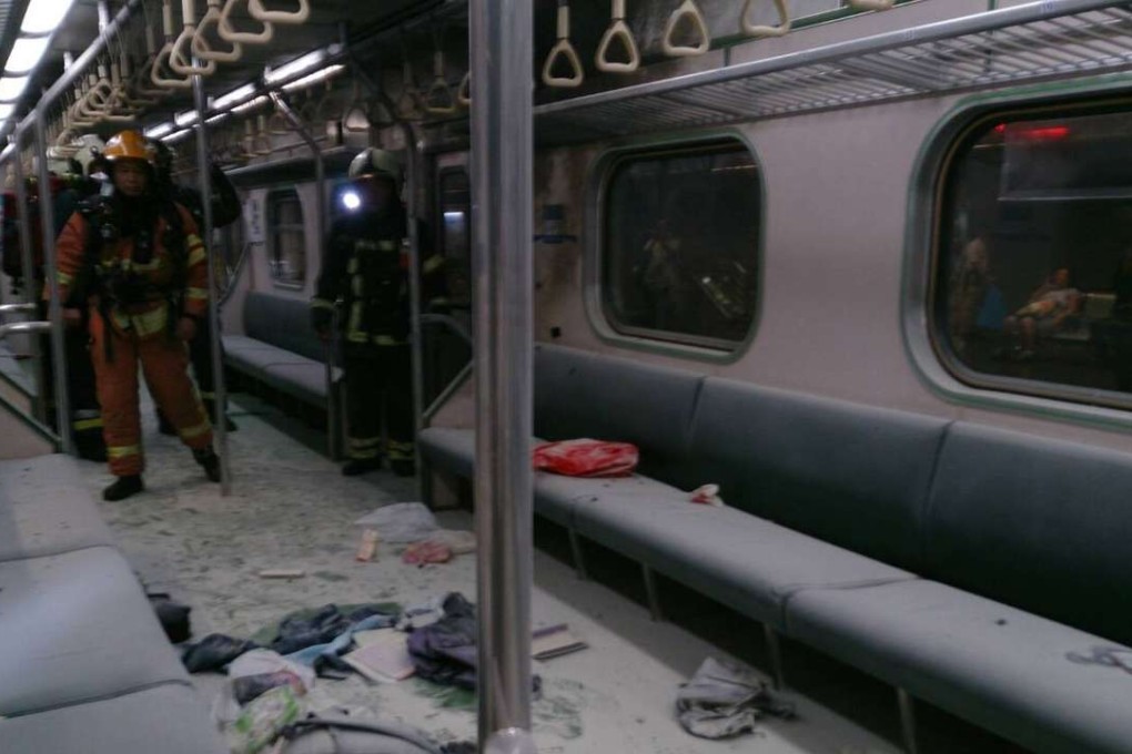 Emergency crews examine a commuter train after an explosion tripped through a carriage. Photo: SCMP Pictures