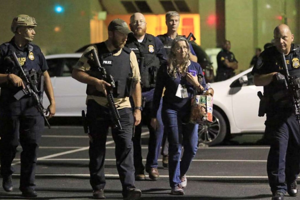 Dallas police officers escort a woman near the scene where eleven Dallas police officers were shot and five have now died on July 7, 2016 in Dallas, Texas. Photo: AFP