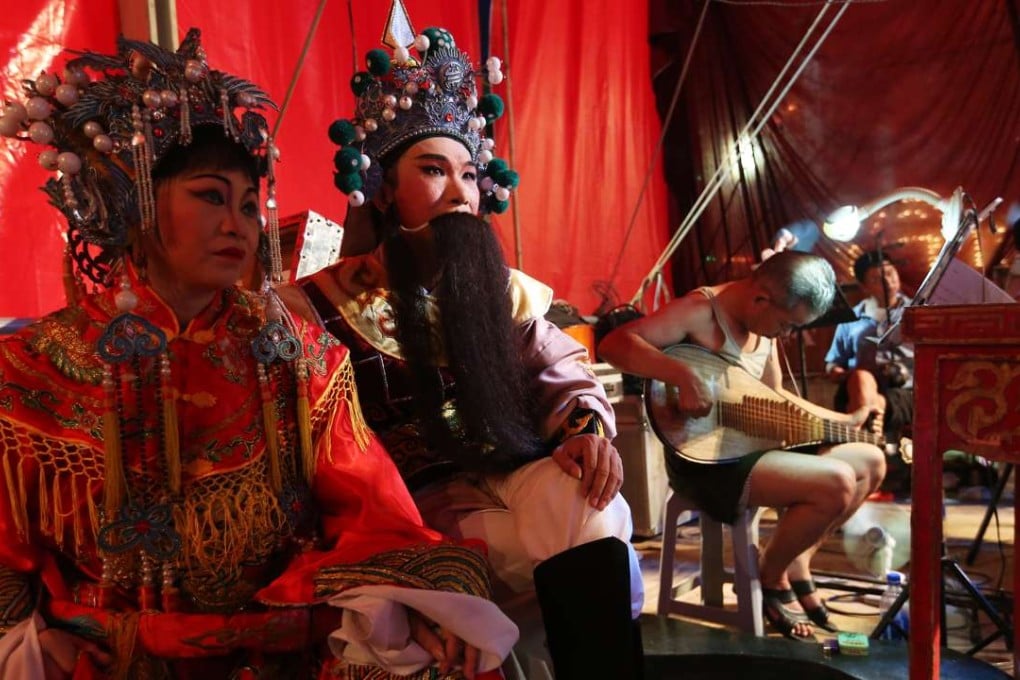 Chinese opera actors prepare for a performance during the Hungry Ghost Festival at a makeshift theatre in Shau Kei Wan. Photo: Sam Tsang
