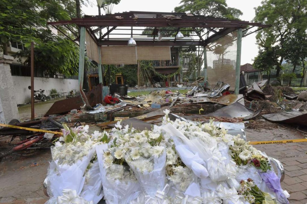Flowers have been left in front of the Holey Artisan Bakery cafe in Dhaka. Photo: Kyodo