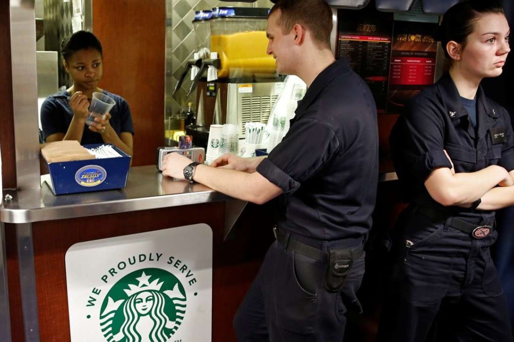 US Navy sailors wait in line for Starbucks coffee on board of the USS Harry S. Truman aircraft carrier in the eastern Mediterranean Sea. Photo: Reuters