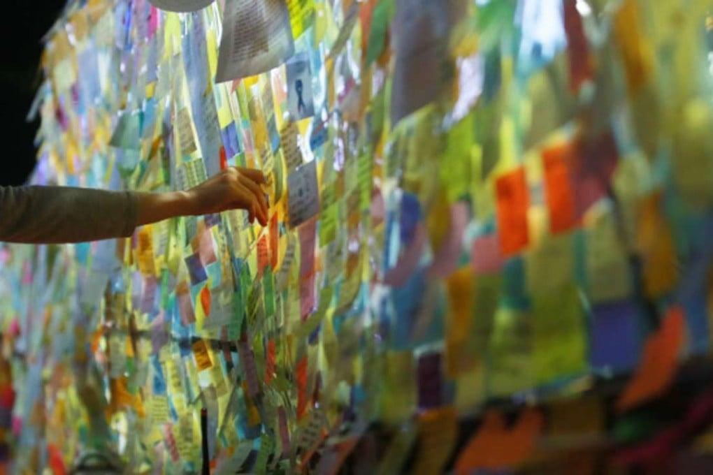 Hundreds of mourners attended a candlelight vigil after the 23-year-old victim was stabbed to death by a stranger at a public bathroom in May. Photo: Yonhap