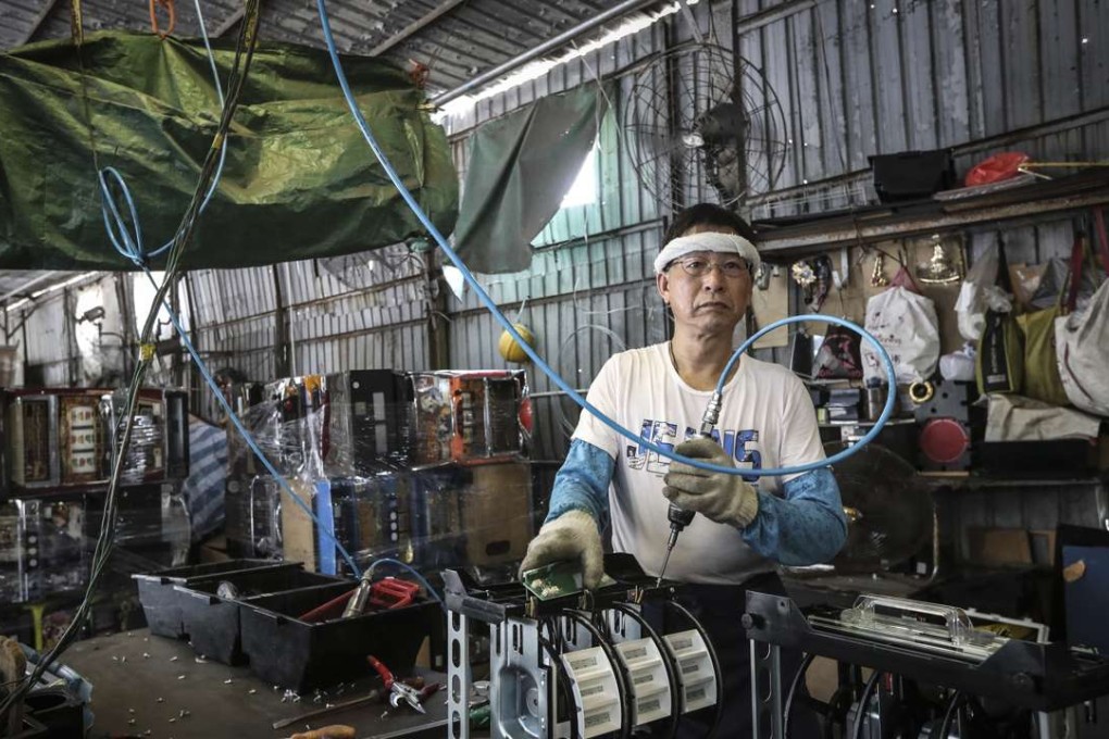 A worker at an e-waste dumping ground in Yuen Long. Photo: Bruce Yan