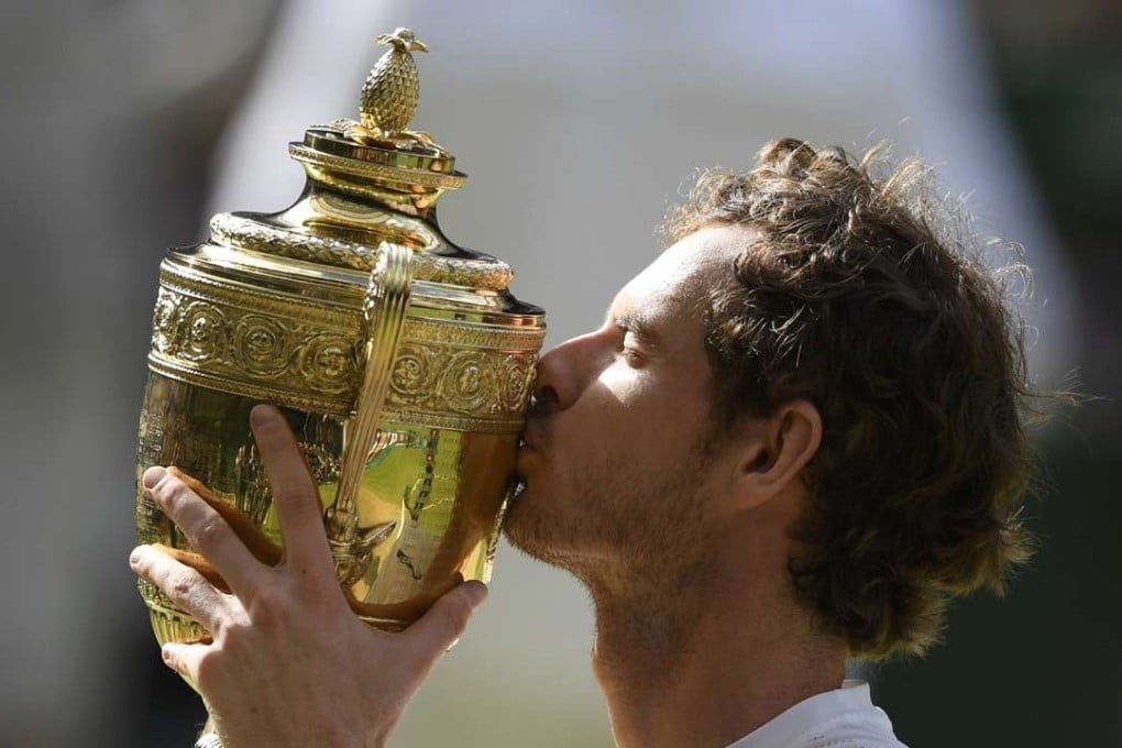Andy Murray kisses the trophy as he celebrates winning the mens singles final against Canada's Milos Raonic REUTERS/Tony O'Brien
