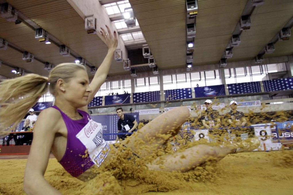 Daria Klishina lands in the sand during a long jump event at the Russian Winter IAAF Indoor Athletic championship in Moscow. Photo: AP