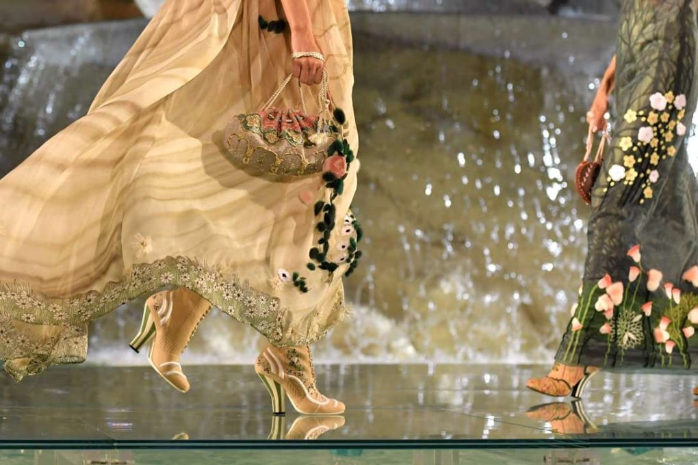 Models strut the transparent catwalk over the Trevi fountain. Photo: AFP