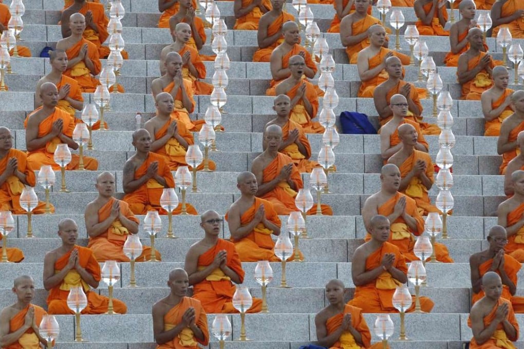 Thai Buddhist monks pray and gather at a temple. Photo: AP
