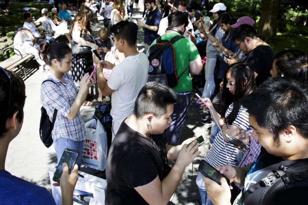 A group of people Pokémon Go on their smartphones converge in Union Square in New York on Monday as they hunt for monsters. Photo: EPA