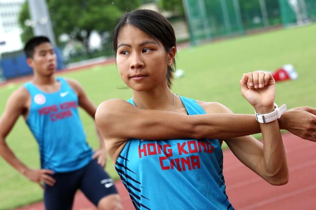 Christy Yiu warms up with long jumper Chan Ming-tai as they meet the press at the Hong Kong Sports Institute in Fo Tan on Tuesday. Photos: Jonathan Wong