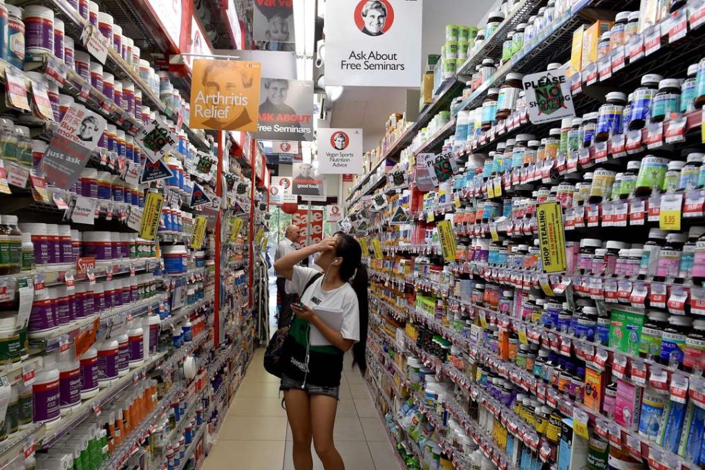 Customers browsing products at a supplement outlet in Sydney, Australia. Photo: AFP