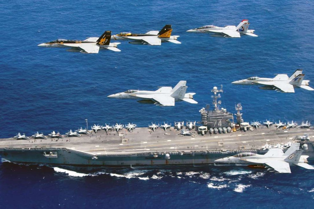 US fighter planes fly above the Nimitz-class aircraft carrier USS John C. Stennis in the Philippine Sea. Two US aircraft carriers have started exercises in the area, defence officials said on June 19, as Washington's ally Manila faces growing pressure from Beijing in the South China Sea. Photo: AFP