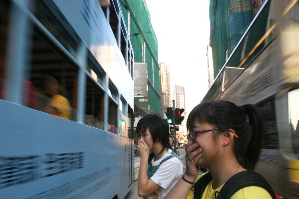 Pedestrians covering their noses in Causeway Bay. Photo: Felix Wong