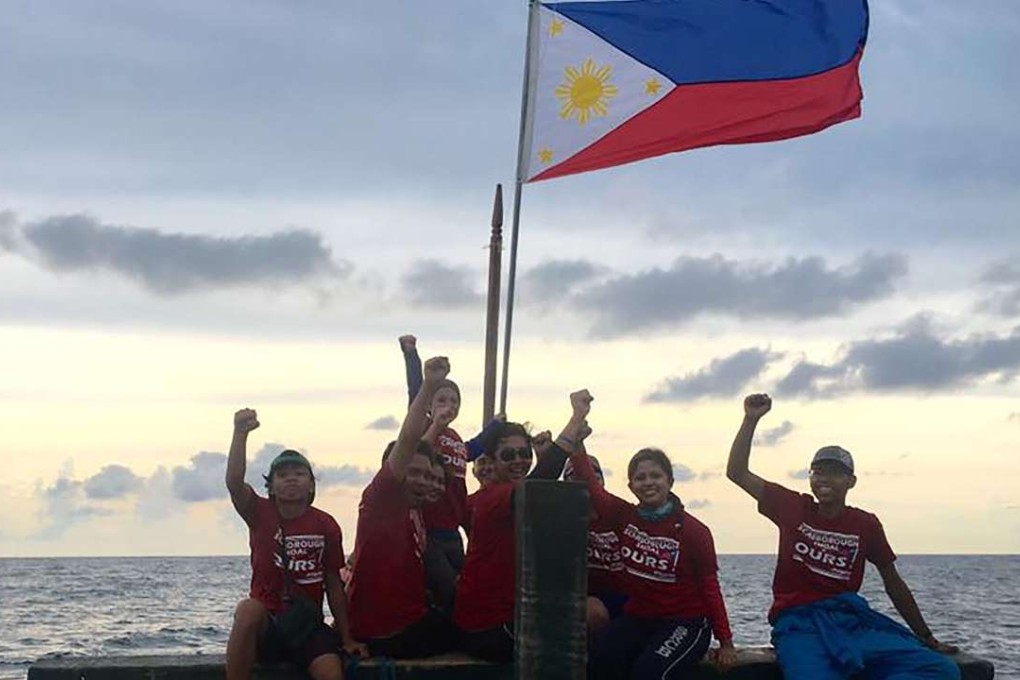 Filipino activists pose for a photo at the Chinese-controlled Scarborough Shoal in the South China Sea. Photo: AFP