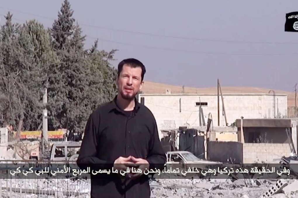 An image grab taken from a video released by the Islamic State group in 2014 shows kidnapped British reporter John Cantlie standing in a war-damaged town. Photo: AFP