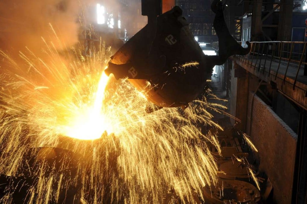 An employee monitors molten iron being poured into a container at a steel plant in Hefei, Anhui province. China is accused of threatening the viability of steel firms around the world. Photo: Reuters