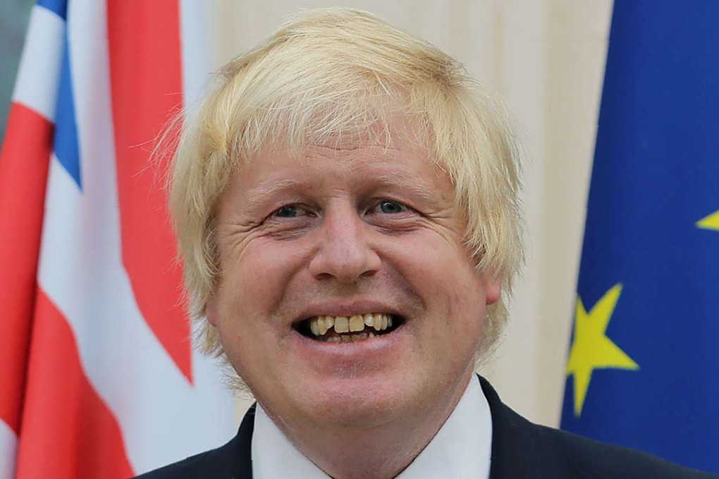 British Foreign Secretary Boris Johnson stands between a Union FLag and a European Union (EU) flag during a reception at the French Ambassador's residence in west London. Photo: AFP