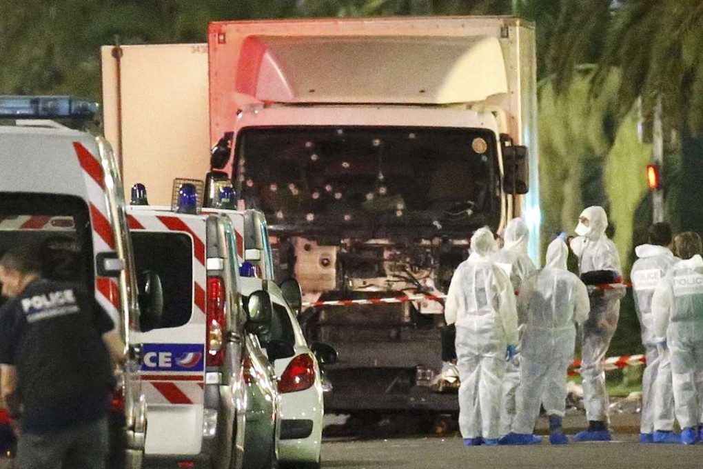 French police forces and forensic officers stand next to a truck July 15, 2016 that ran into a crowd celebrating the Bastille Day national holiday on the Promenade des Anglais killing at least 60 people in Nice, France, July 14.Photo: REUTERS