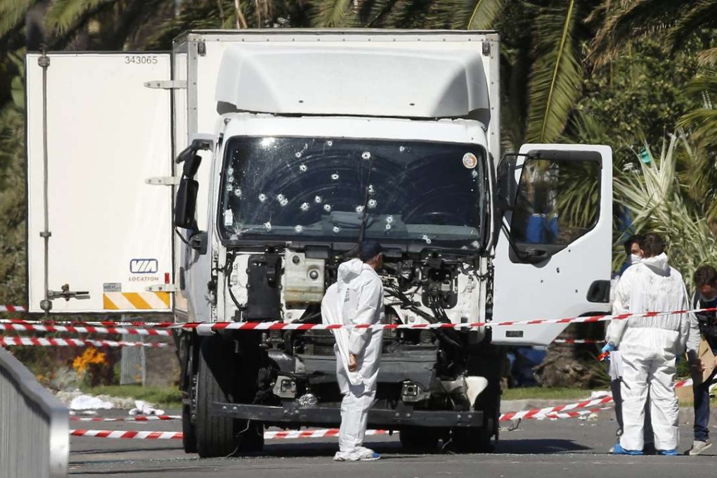Police officers work near the truck that mowed through revellers in Nice. Photo: Reuters