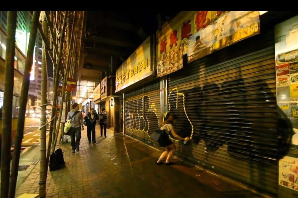 American graffiti artist Utah spray-paints at an unknown location in Hong Kong.