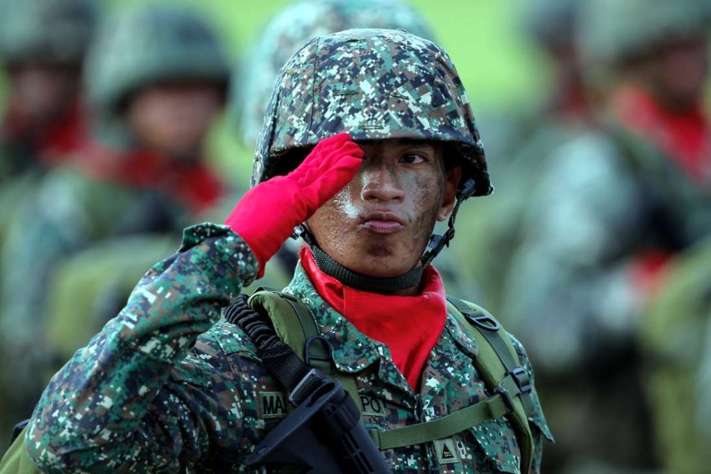 A Filipino soldier salutes during a parade. The Philippines is beefing up its military with the procurement of fighter jets from South Korea. Photo: EPA
