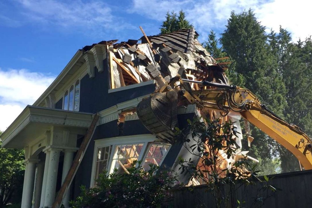 A backhoe destroys a C$6 million mansion in Vancouver's Shaughnessy neighbourhood this year. The destruction of the well-kept home prompted community outrage and was cited in a briefing for Canadian tax auditors looking into Vancouver real estate transactions. Photo: Twitter / @DeborahAMG