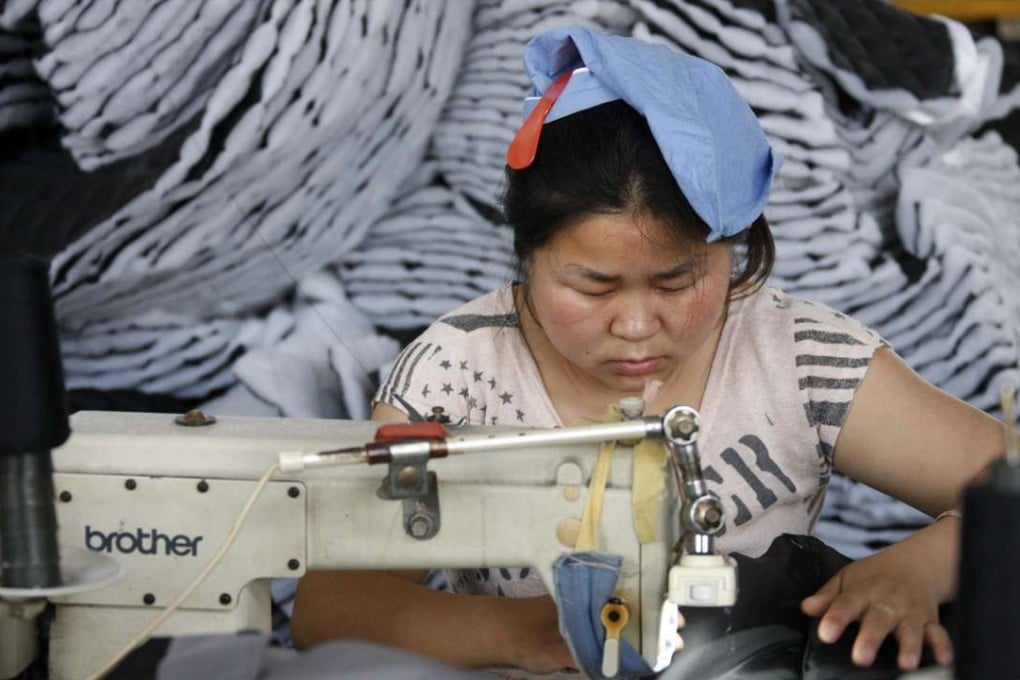 Nationwide, wages rose about 11 per cent in the first half of the year, against 13.5 per cent for the same period last year. Above, a worker at a clothing factory in Huaibei, Anhui province. Photo: AFP