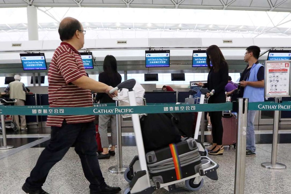 Cathay Pacific check-in desks at Hong Kong International Airport. The company warned on Monday that its first-half performance was “below expectations”. Photo: Felix Wong
