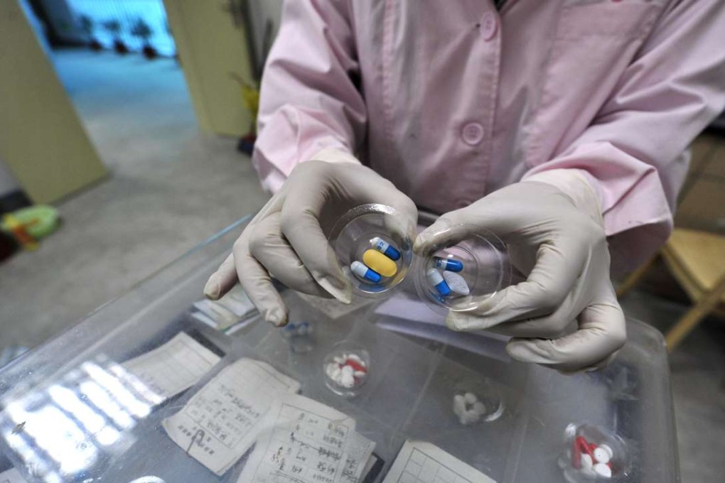 A Chinese nurse prepares the cocktail of drugs for Aids patients in a special ward in a Chongqing hospital. Photo: AFP