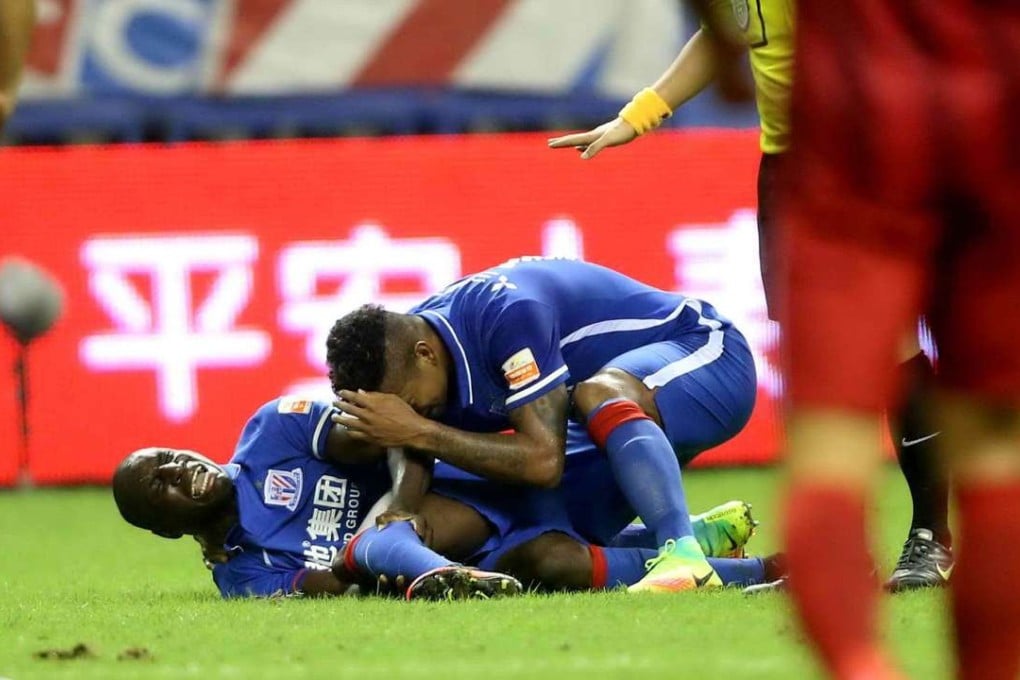 Demba Ba of Shanghai Shenhua reacting after breaking his left leg against Shanghai SIPG. Photos: AFP