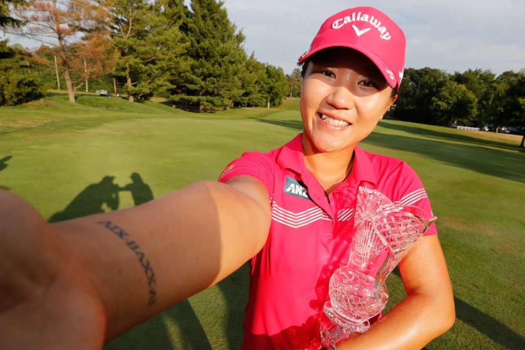 Lydia Ko poses with the championship trophy after winning the Marathon Classic. Photos: AFP