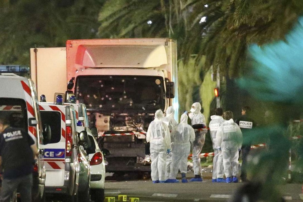 French police and forensic officers stand next to the truck used in the Bastille Day attack in Nice. Photo: Reuters