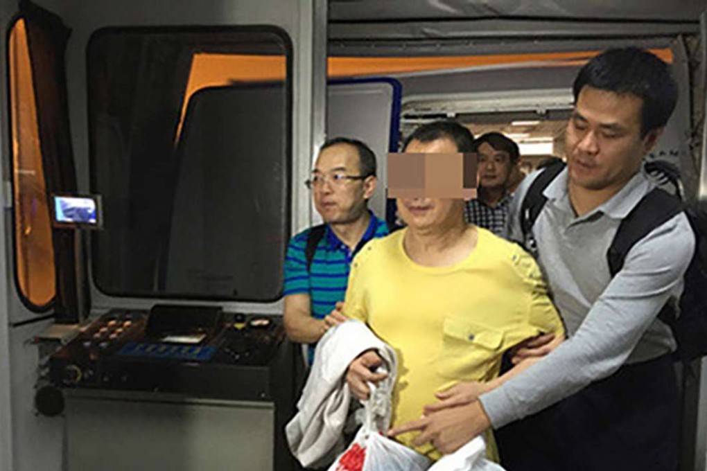 The suspect is escorted from an aircraft in Beijing. Photo: Legal Daily