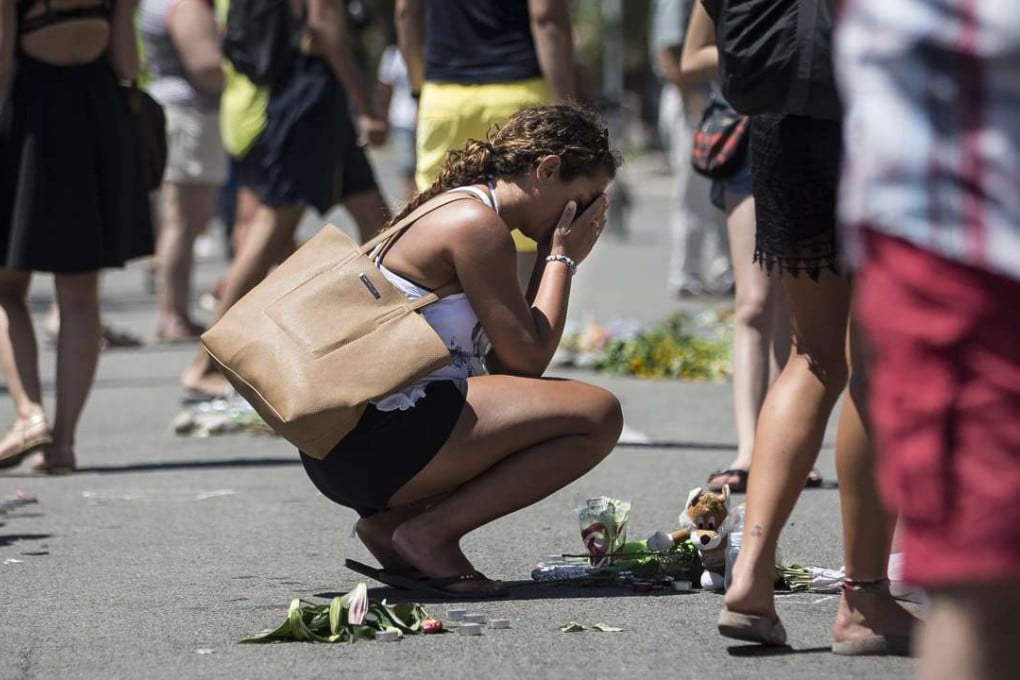 A woman mourns on the Promenade des Anglais, scene of the most recent terrorist atrocity in France. Photo: EPA