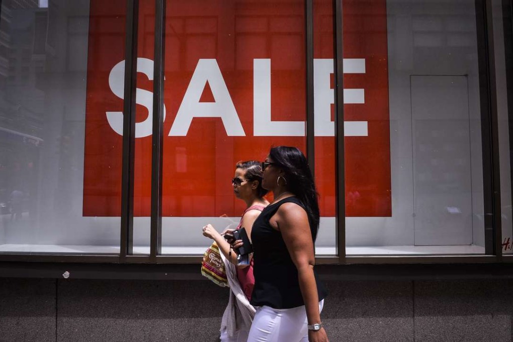 Pedestrians walk past an H&M clothing store in Philadelphia, Pennsylvania. Photo: Bloomberg