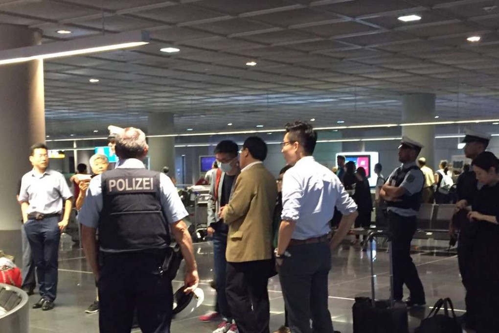 Chinese vice-consul general Xing Weiping (in brown jacket) waits for relatives at Frankfurt airport. Photo: Christy Leung