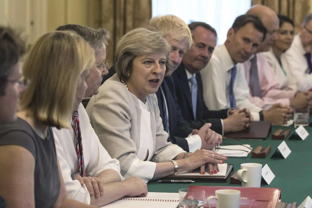 Britain's Prime Minister Theresa May (centre) holds her first cabinet meeting at Downing Street, in London, on Tuesday. Photo: Reuters