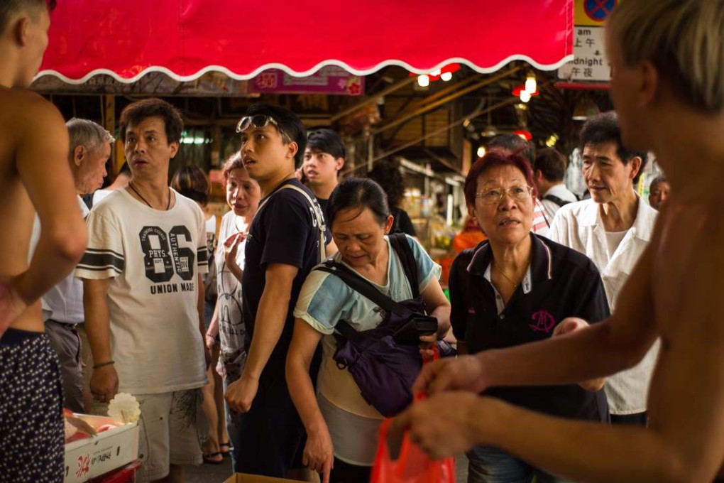 Vendors sell fruit at a street market. Nobody in Hong Kong is “entitled” to a livelihood and we all work hard to pay our bills. Photo: AFP