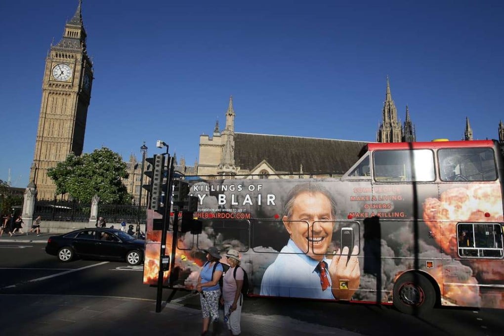 A bus with an advertisement for a film about Tony Blair passes the Houses of Parliament in London. Photo: AFP
