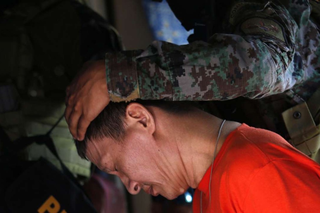 Convicted Chinese drug dealer Peter Co is escorted by police commandos at the national prison in Muntinlupa city, south of Manila, after they took over security from jail guards. Photo: EPA